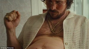 Irving Rosenfeld (Christian Bale) kind-of admires his gut in American Hustle